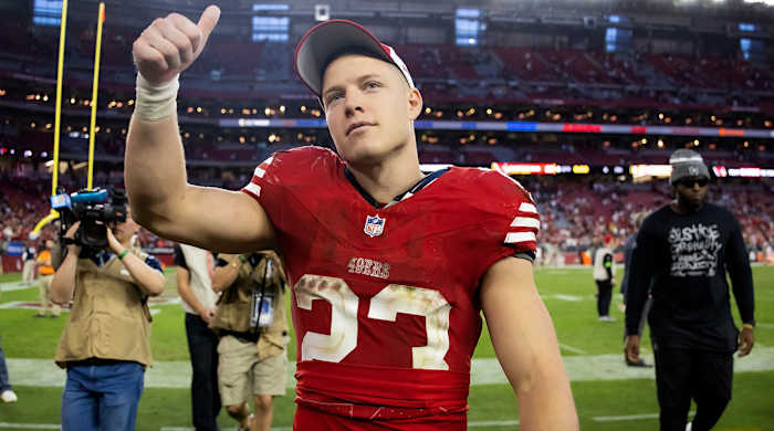 Christian McCaffrey walks off the field after the 49ers’ win over the Cardinals.